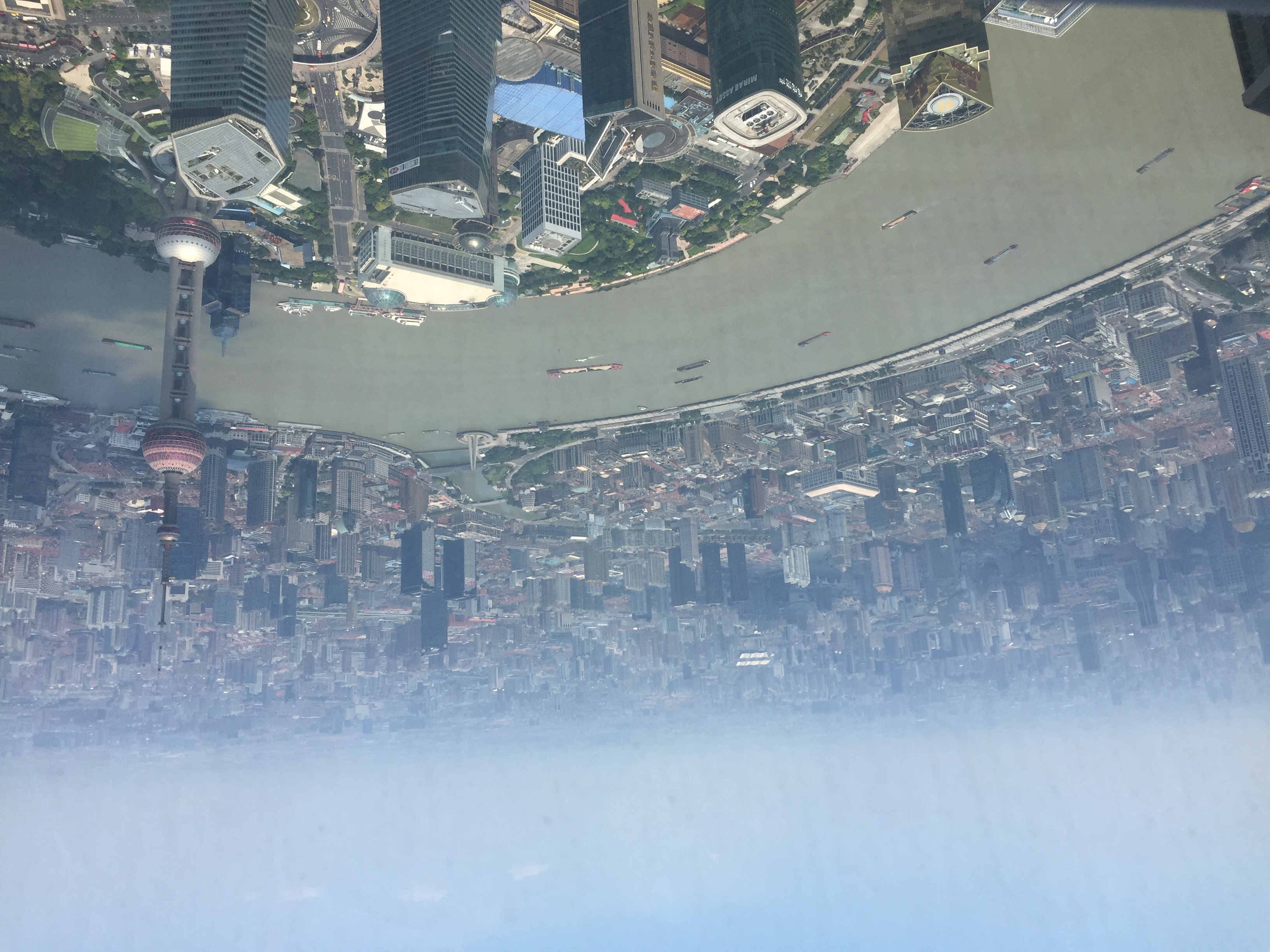 A high view over Shanghai from the Shanghai Tower Observation Deck, with the Huangpu River curving through the city below