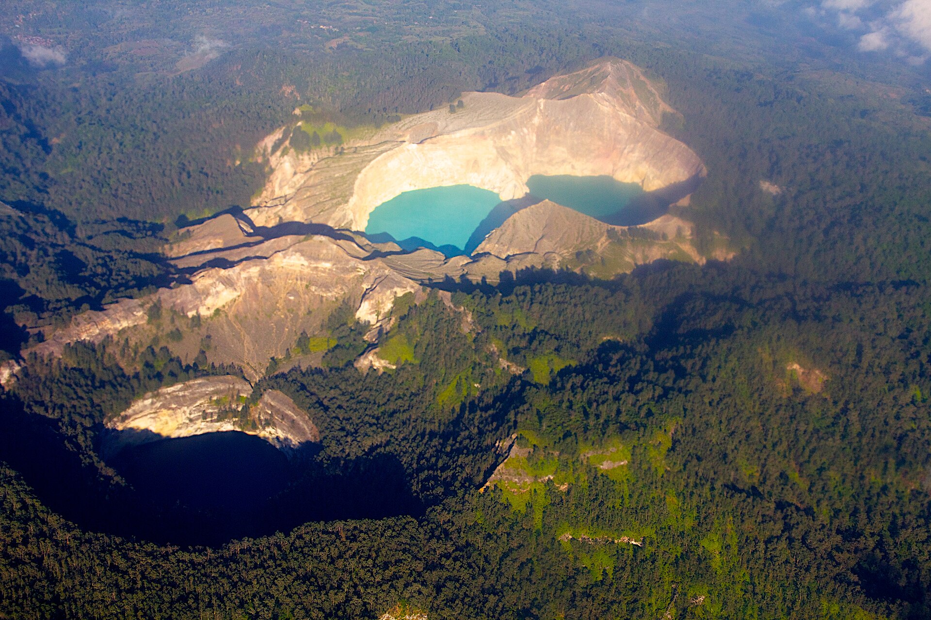 Kelimutu from the air — the crater lakes set into the green volcanic highlands of Flores